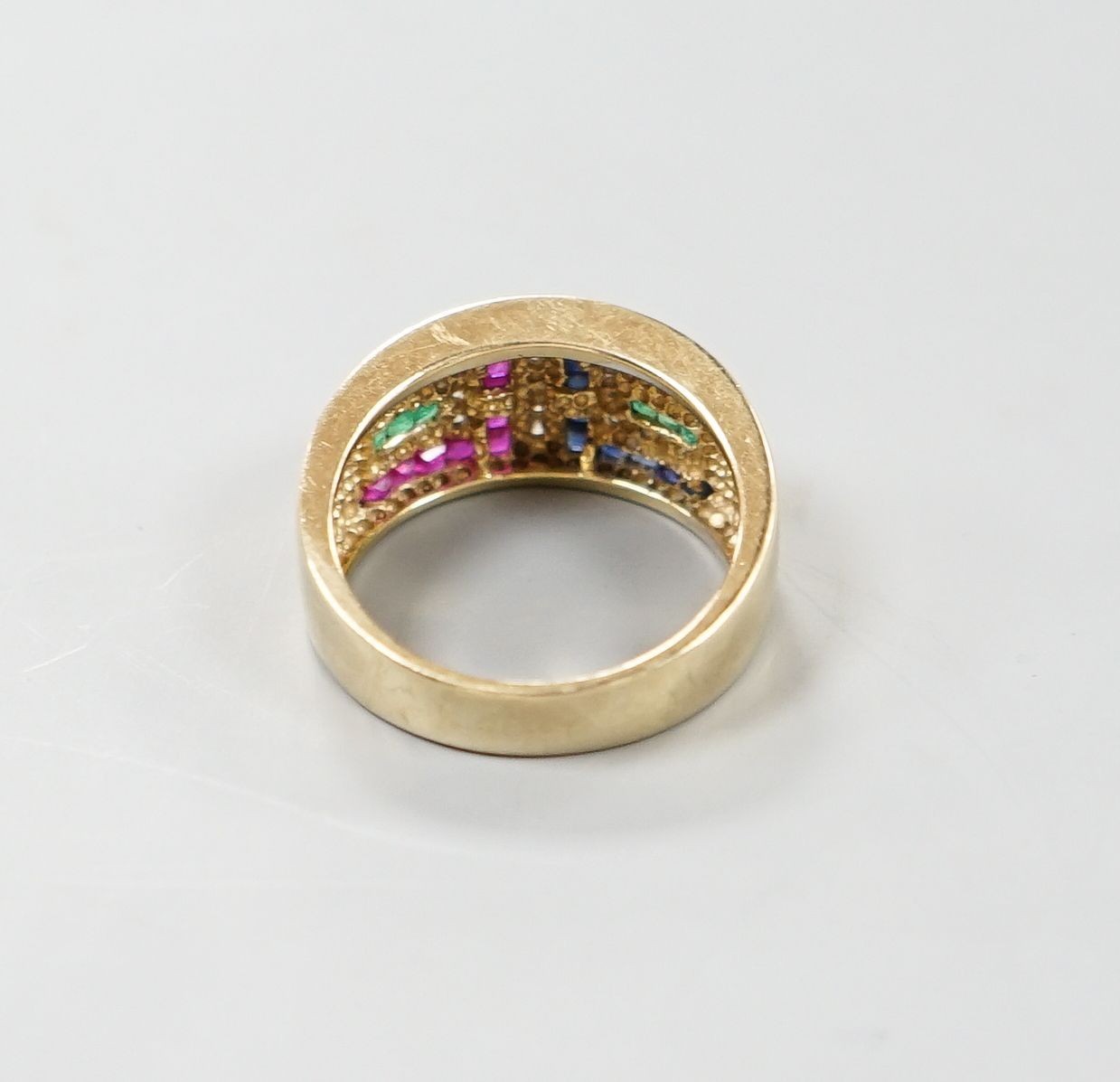 A modern 9ct gold, emerald, ruby, sapphire and diamond set geometric dress ring, size Q, gross weight 5.3 grams.